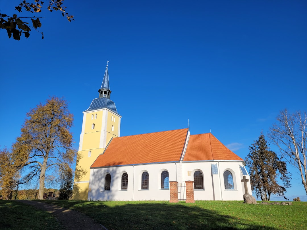 a white church with a red roof and a steeple